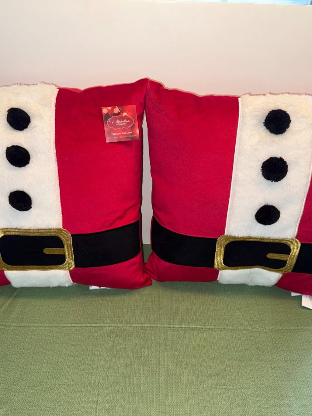 Two St. Nicholas Square accent pillows with a Santa theme